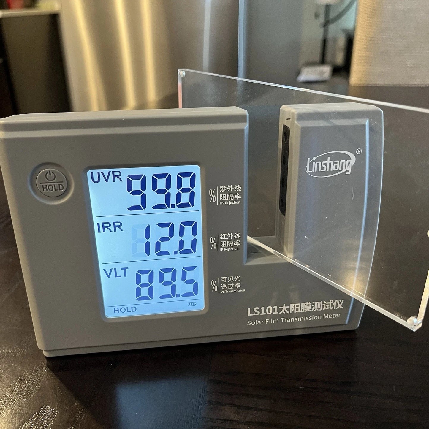 An acrylic panel in an UVR tester showcasing a high UV Rejection rate of over 99 percent.