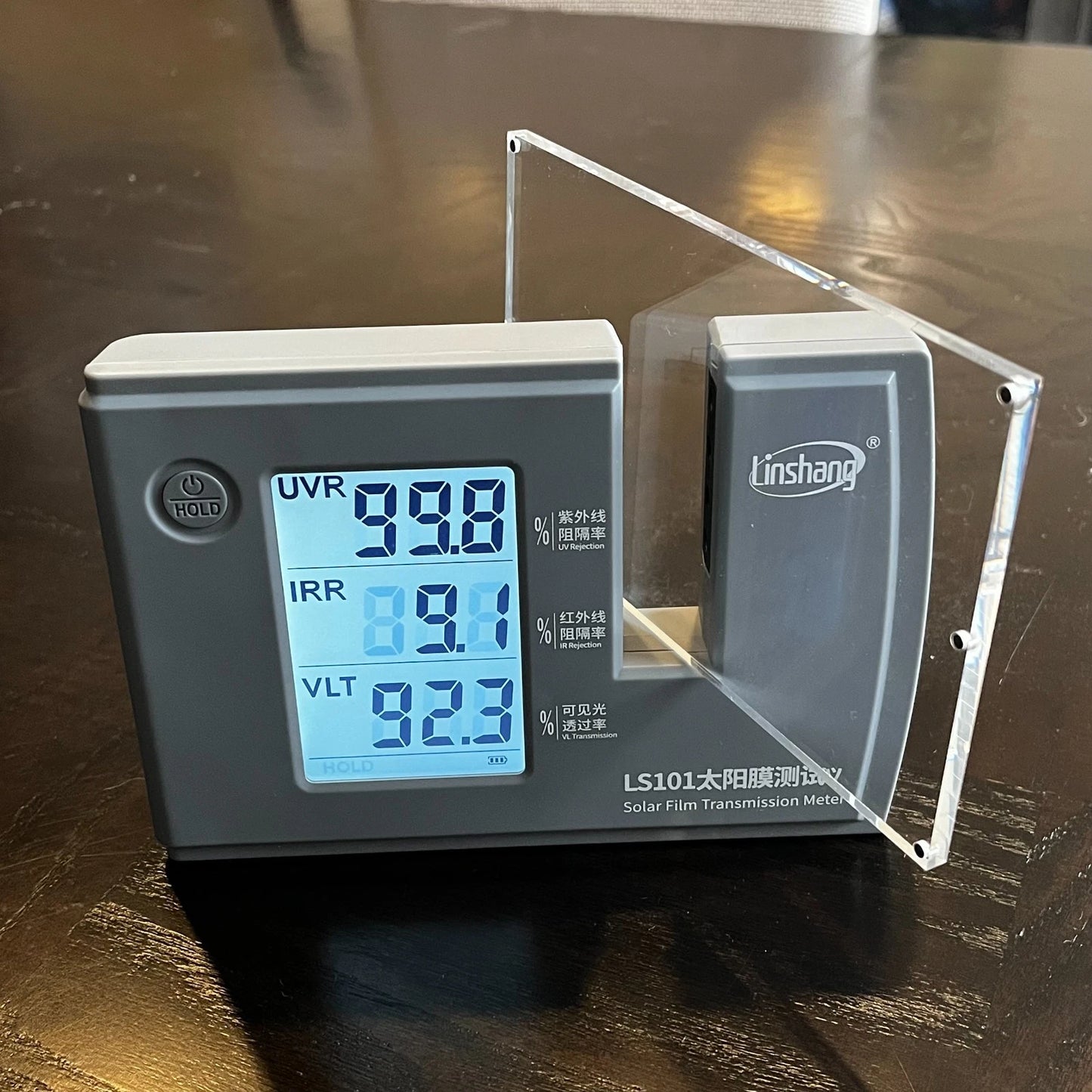An acrylic panel in an UVR tester showcasing a high UV Rejection rate of over 99 percent.