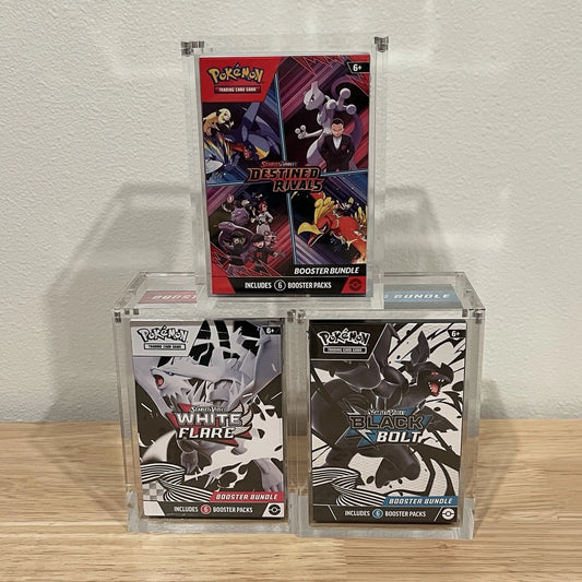Pokemon booster bundles Destined Rivals, Black Bolt and White Flare from the Scarelet and Violet Series on display in clear acrylic cases.