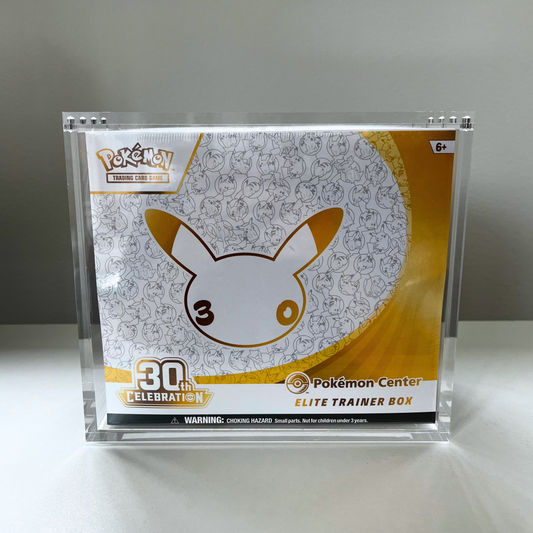 Pokémon Center Elite Trainer Box 30th Celebration edition in a clear acrylic stand, featuring Pikachu artwork on the front.
