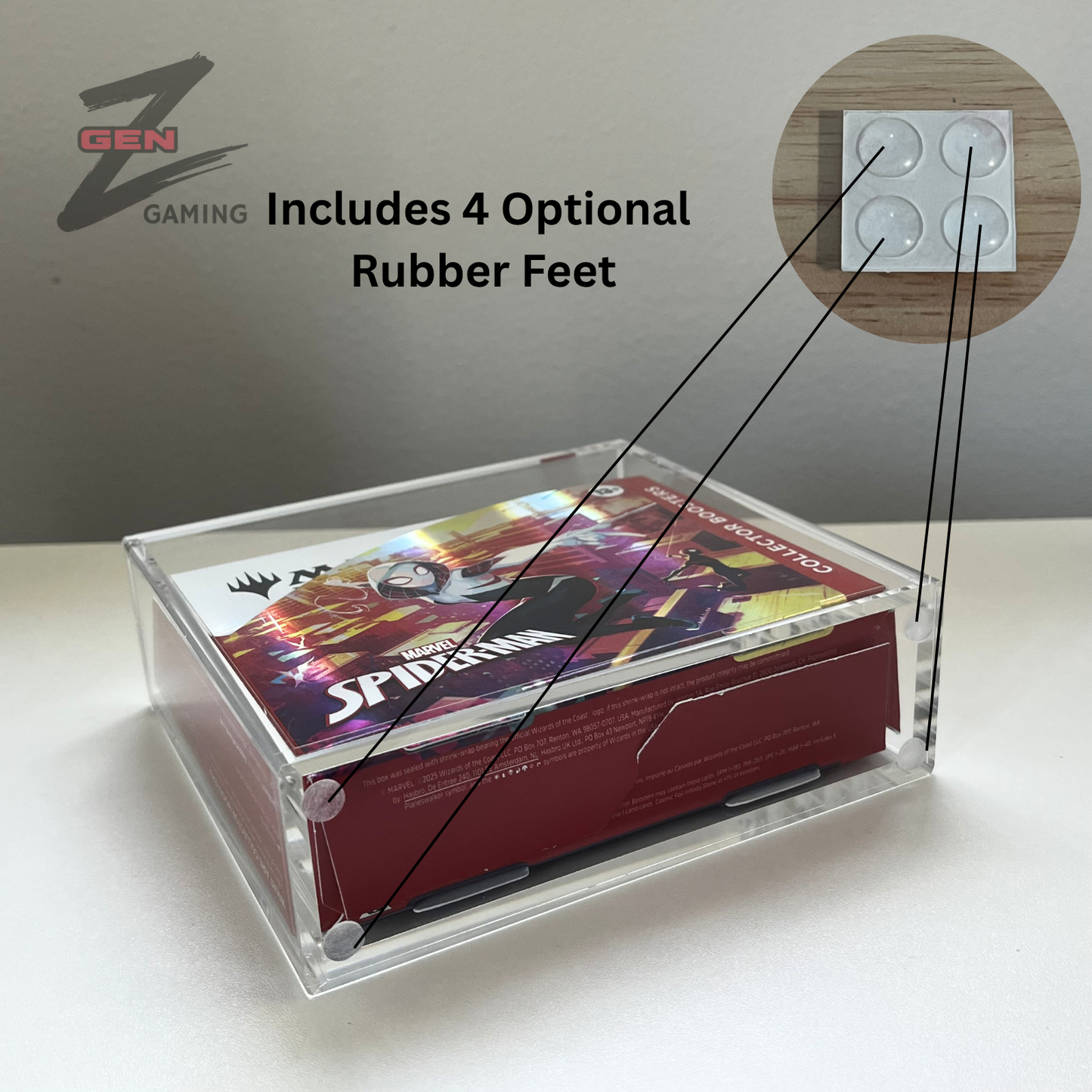 Clear acrylic display case containing a Magic the Gathering MTG Spider-Man themed card or box insert, shown on a light surface with a gray background. Text reads 'Includes 4 Optional Rubber Feet,' and a circular inset shows the rubber feet.