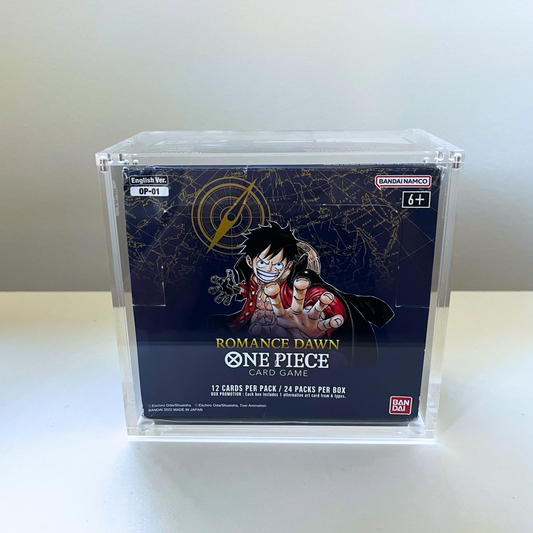 A clear acrylic display box holding a Bandai Namco Romance Dawn One Piece Card Game box, set against a plain light gray background.