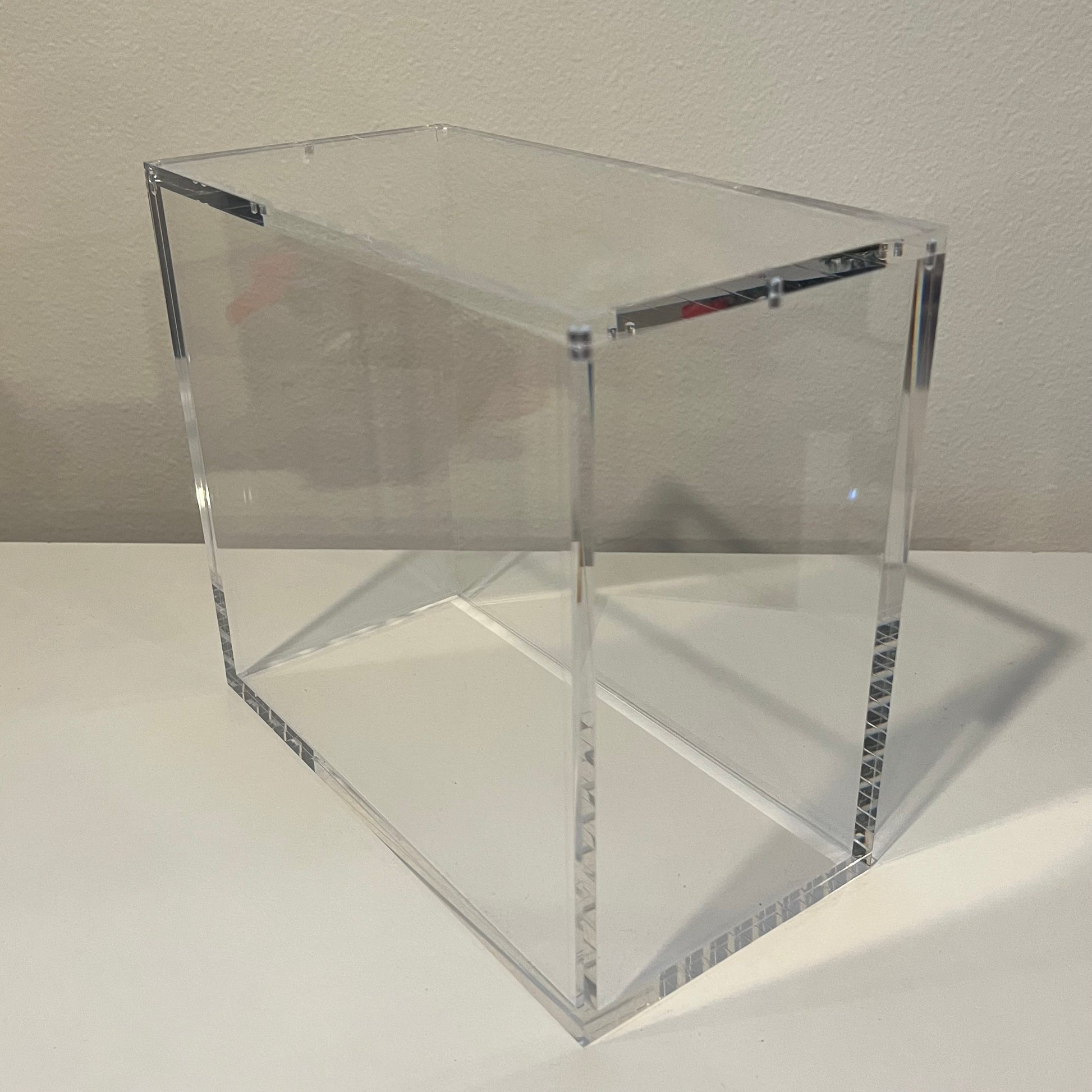 An empty pokemon acrylic protective case ready for storage or display of a pokemon ETB Elite Trainer Box.