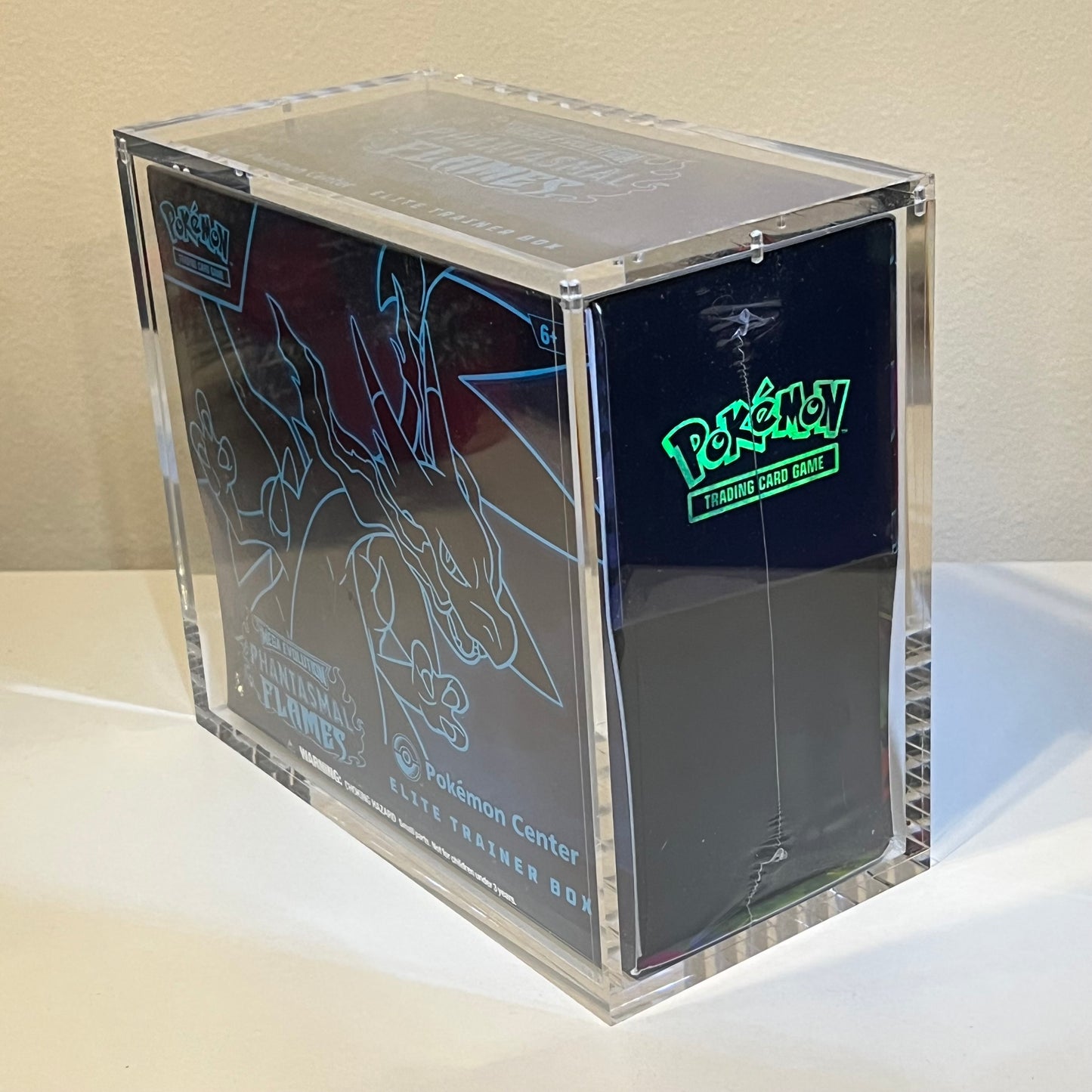 Side view of a Pokémon Center Elite Trainer Box Phantasmal Flames in a museum quality acrylic display case.